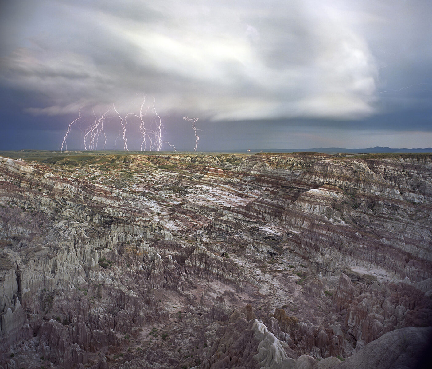 hoodooo rock formation and lightming storm in how's half acre Wyoming