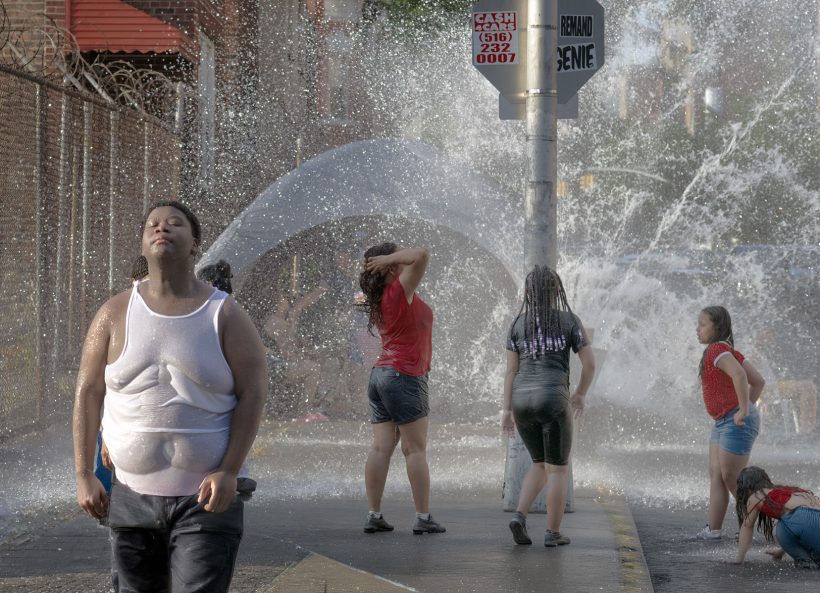 July 4, 2026 children play in an open fire hydrant on Walton Avenue in the Fordham section of the Bronx