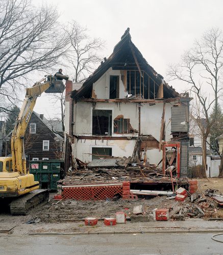 Demolition Crew Salvaging a Vent Stack Lead Pipe